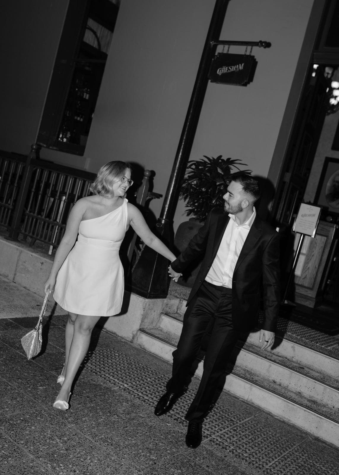 Jessie and Sean dressed up and holding hands outside The Gresham